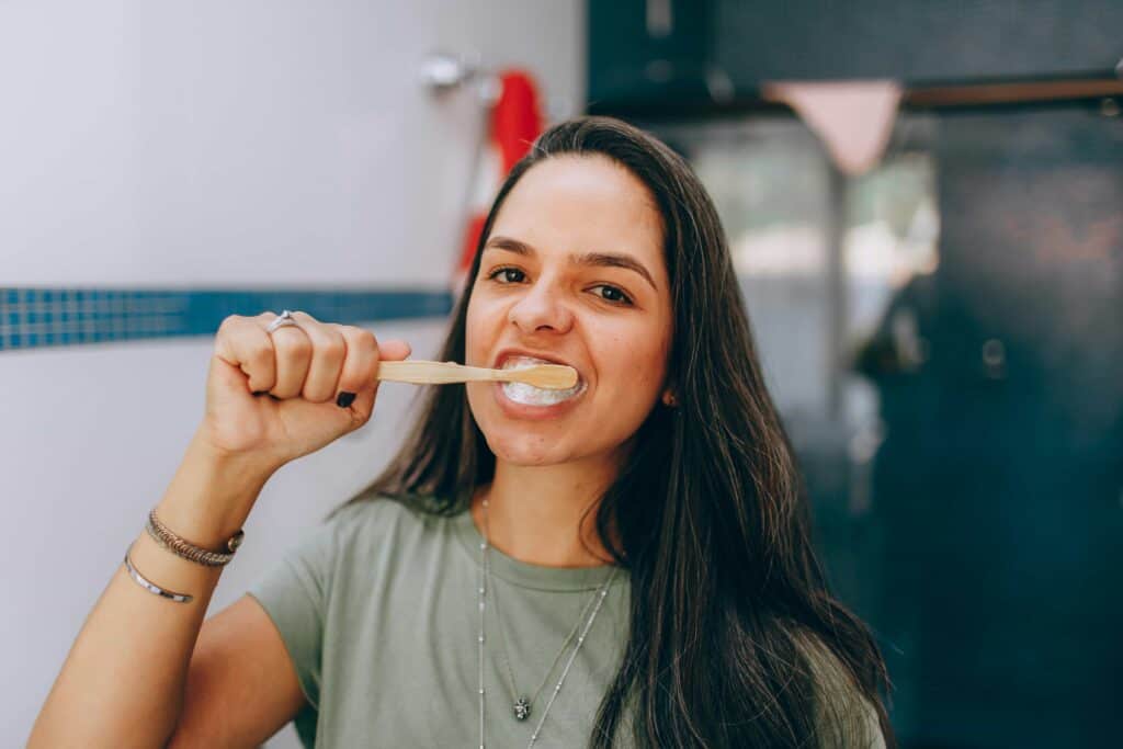 girl brushing her teeth and braces
