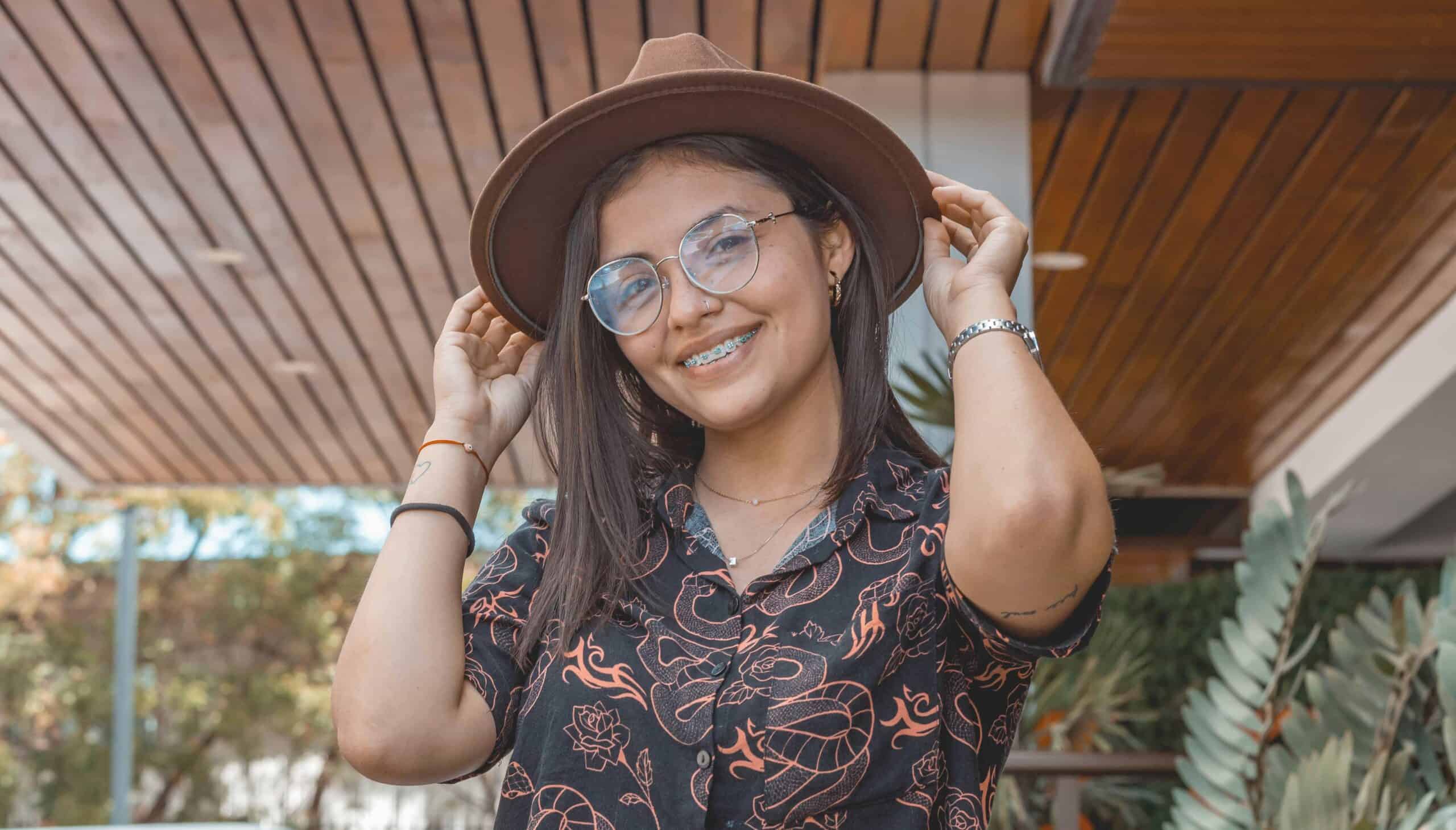 girl posing with hat